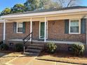 Inviting front porch entry to a brick home at 1641 Bridgedale Dr, Rocky Mount, NC 27803