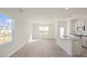 Open concept kitchen and dining area with island and hardwood flooring at 184 Starlight St, Sanford, NC 27330