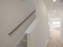 Modern staircase with gray railing leading to the second floor at 184 Starlight St, Sanford, NC 27330