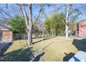 Spacious backyard with mature trees and a chain link fence at 210 Earl St, Rocky Mount, NC 27804