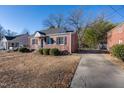 Brick home with a driveway and mature trees in the yard at 210 Earl St, Rocky Mount, NC 27804