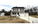 Two-story house with a two-car garage and landscaping at 262 Starry Sky Dr, Benson, NC 27504