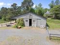 Rustic barn with fencing, providing a classic, rural feel to the property at 265 Verde Rd, Apex, NC 27523