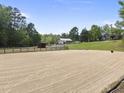 Spacious outdoor paddock with riding area; multiple horse facilities on the property at 265 Verde Rd, Apex, NC 27523