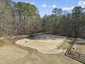 Spacious sand riding arena, surrounded by trees at 265 Verde Rd, Apex, NC 27523