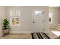 Bright entryway with white door, hardwood floors, and a potted plant at 343 Foster St, Burlington, NC 27217