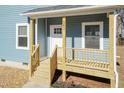 Wooden front porch with white door and railing at 343 Foster St, Burlington, NC 27217