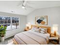 Virtually staged bedroom with large window and ceiling fan at 3743 Bison Hill Ln, Raleigh, NC 27604