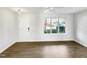 Bright living room featuring hardwood floors and large window at 3743 Bison Hill Ln, Raleigh, NC 27604