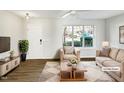 Virtually staged living room with beige sofas and wood floors at 3743 Bison Hill Ln, Raleigh, NC 27604