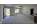 Spacious living room with high ceilings, carpet, and access to the kitchen at 39 Shiloh Dr, Lillington, NC 27546