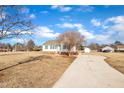 House exterior with a long driveway and mature trees at 3901 La Varra Dr, Clayton, NC 27520