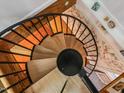 Unique spiral staircase featuring decorative wallpaper and natural wood steps at 497 Turn Key Way, Pittsboro, NC 27312