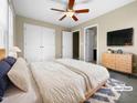 Spacious bedroom with double doors and ceiling fan at 5023 Lalex Ln, Cary, NC 27519