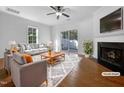 Virtually staged living room featuring a fireplace and hardwood floors at 520 Matheson Pl, Cary, NC 27511
