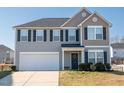 Two-story house with gray siding, white garage door, and landscaping at 1134 Aster Way, Burlington, NC 27215