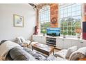 Living area with leather couches, coffee table, and built in shelving at 1535 Caraleigh Mills Ct # 221, Raleigh, NC 27603