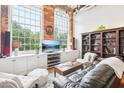 Living room with a large TV, comfy seating, and built-in shelving at 1535 Caraleigh Mills Ct # 221, Raleigh, NC 27603