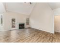 Bright living room featuring a fireplace, hardwood floors, and neutral walls with access to the backyard deck at 316 Trafalgar Ln, Cary, NC 27513