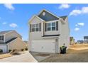 Two-story house featuring gray siding, a white double garage door, and a small front yard at 326 Armistead Ct, Burlington, NC 27217