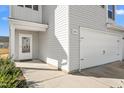 Front entrance with white door, gray siding, and a walkway at 326 Armistead Ct, Burlington, NC 27217