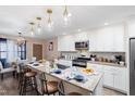 Bright, eat-in kitchen features an island with seating and stainless steel appliances at 402 W Clay St, Mebane, NC 27302
