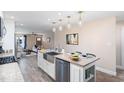 Open concept kitchen with island, stainless steel appliances, and hardwood floors at 402 W Clay St, Mebane, NC 27302