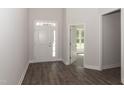 Bright entryway with hardwood floors, white door, and access to another room at 572 Glenkirk Pl, Garner, NC 27529