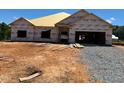 New construction home featuring a two-car garage, and a large front yard waiting for landscaping at 572 Glenkirk Pl, Garner, NC 27529