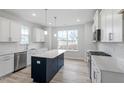 Modern kitchen featuring white cabinets, stainless steel appliances, and a center island at 704 Georgia'S Landing Pkwy # 15, Raleigh, NC 27603