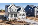 Charming two-story home featuring a well-manicured lawn, covered porch, and attached two-car garage at 102 Belmont Stakes Ln, Wendell, NC 27591