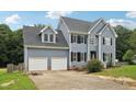 Two-story house with gray siding, black shutters, and a two-car garage at 102 Ridge Ln, Youngsville, NC 27596