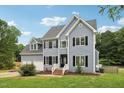 Two-story house with gray siding, black shutters, and a two-car garage at 102 Ridge Ln, Youngsville, NC 27596