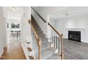 Elegant staircase with wood railing leading to the second floor at 102 Ridge Ln, Youngsville, NC 27596