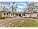 Ranch home with stone accents and a spacious front yard at 1126 Trailwood Dr, Raleigh, NC 27606