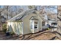 Side view of a yellow house with mature trees and landscaping at 1322 Cedar Branch Ct, Wake Forest, NC 27587