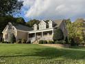 Two-story house with stone and shingle exterior, a front porch, and landscaped yard at 180 Meadow Glen Dr, Wake Forest, NC 27587