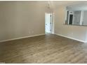 Spacious living room with light-colored walls, hardwood floor, and an open view into the kitchen at 233 N Movado Trl, Kenly, NC 27542