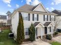 Charming townhome featuring neutral siding, black shutters, and well-manicured greenery in the front yard at 2332 Turtle Point Dr, Raleigh, NC 27604