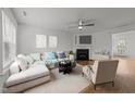 Bright living room featuring a comfortable sectional sofa, fireplace, and neutral décor, perfect for relaxation at 2332 Turtle Point Dr, Raleigh, NC 27604