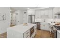Modern white kitchen with stainless steel appliances and island at 29 Enterprise St # 108, Raleigh, NC 27607