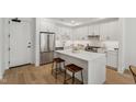 Modern kitchen with white cabinets and center island at 29 Enterprise St # 108, Raleigh, NC 27607