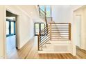 Open staircase with hardwood treads, white risers and contemporary black metal railing at 3315 Hampton Rd, Raleigh, NC 27607