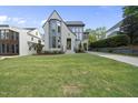 Beautifully landscaped front yard enhances this modern home's curb appeal with a gorgeous green lawn at 3317 Hampton Rd, Raleigh, NC 27607