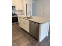 Kitchen island with granite countertop, sink, and dishwasher at 40 Shay St, Angier, NC 27501