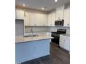 Spacious kitchen with white cabinets, granite countertops, and stainless steel appliances at 40 Shay St, Angier, NC 27501