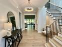 Elegant foyer features hardwood floors, staircase, and modern lighting at 4005 Brevard Pl, Raleigh, NC 27609