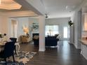 Open living space with hardwood floors, fireplace, and access to dining area at 41 Faircox Way # 137, Garner, NC 27529