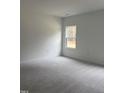 Simple bedroom with carpeted floors and one window at 507 Barnes Landing Dr, Four Oaks, NC 27524