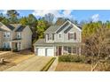 Gray siding two-story house with a two-car garage and landscaping at 631 Virginia Water Dr, Rolesville, NC 27571